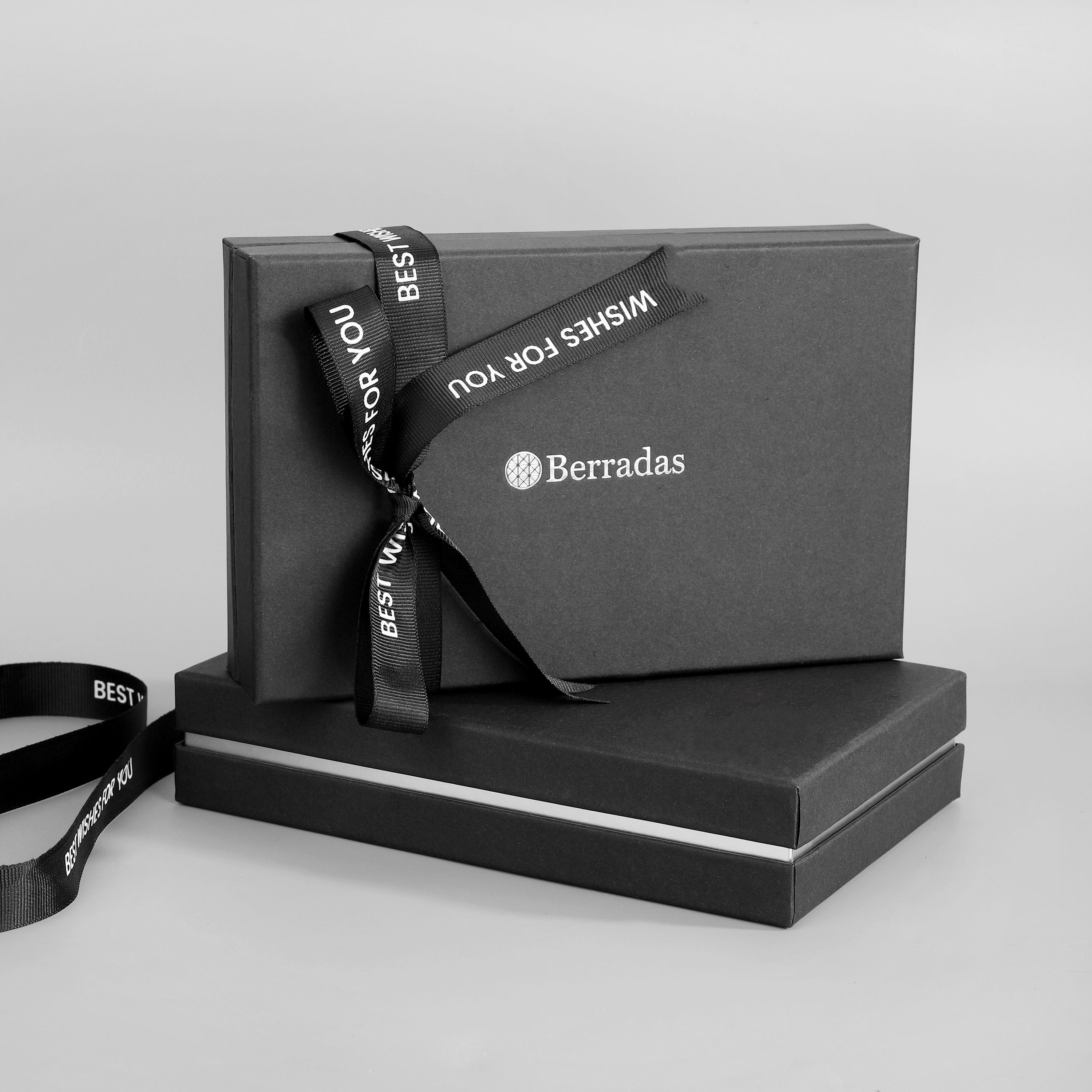 Black gift box with a ribbon and 'Berradas' branding on a light gray background