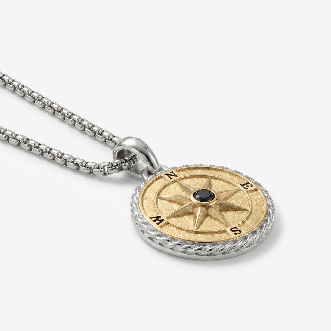 Gold and silver compass pendant necklace on a white background