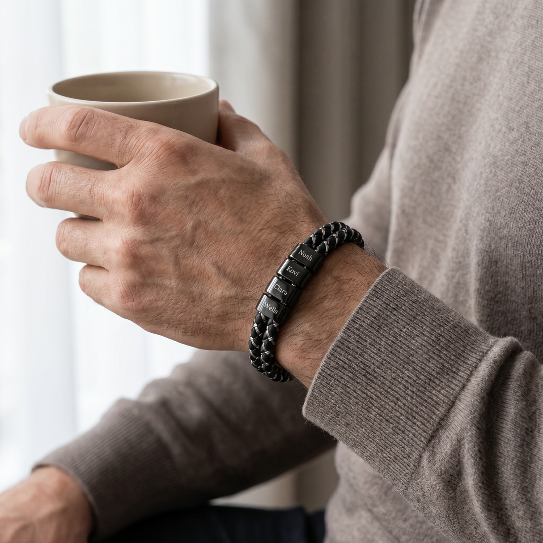 Person holding a mug with a bracelet on a neutral background