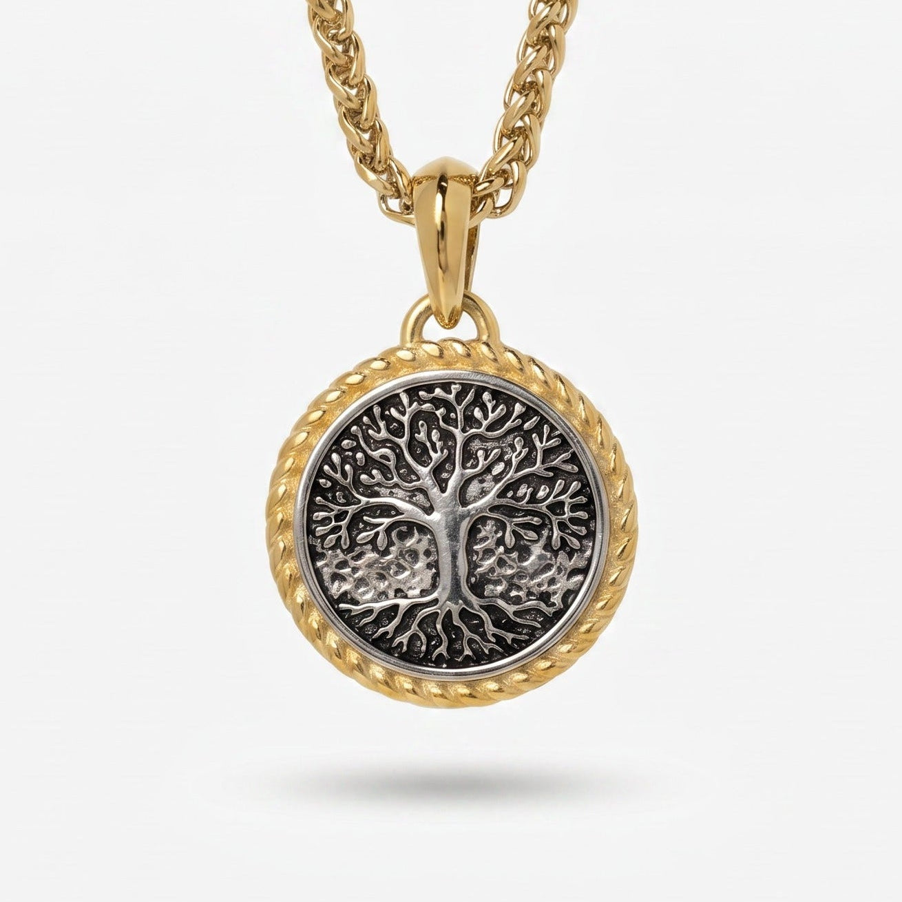 Gold necklace with a tree-of-life pendant on a white background