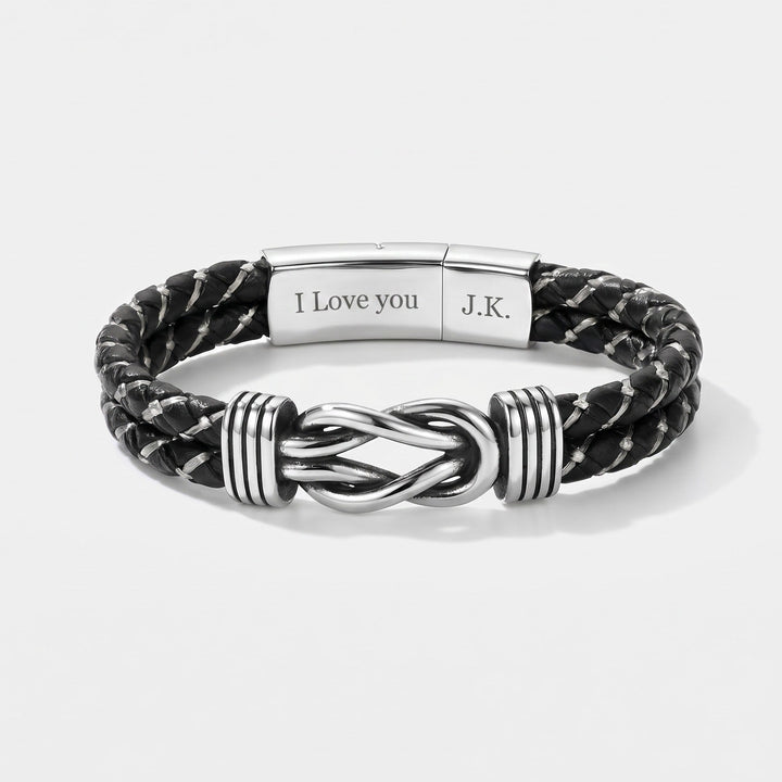 Black braided leather bracelet with silver knot design on a white background