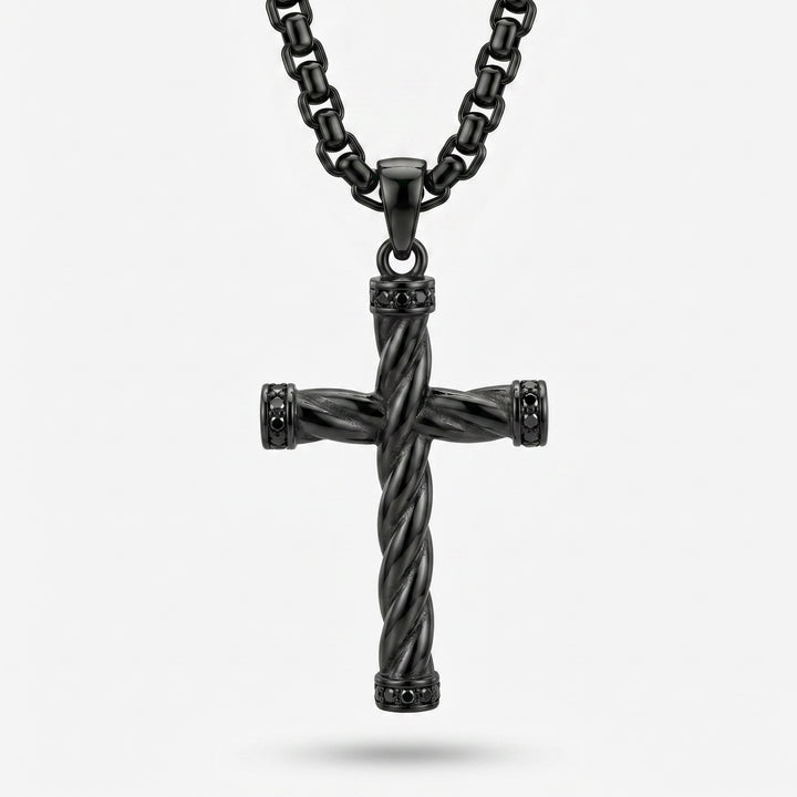 Black twisted cross pendant on a chain against a white background