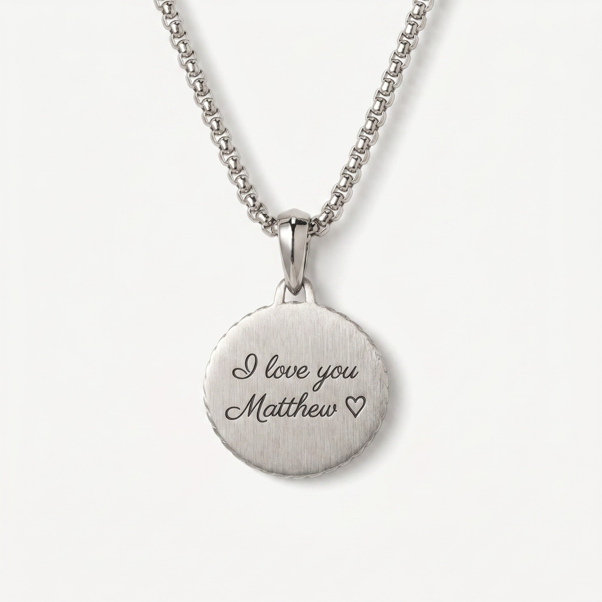 Silver necklace with a round pendant engraved with 'I love you Matthew' on a white background