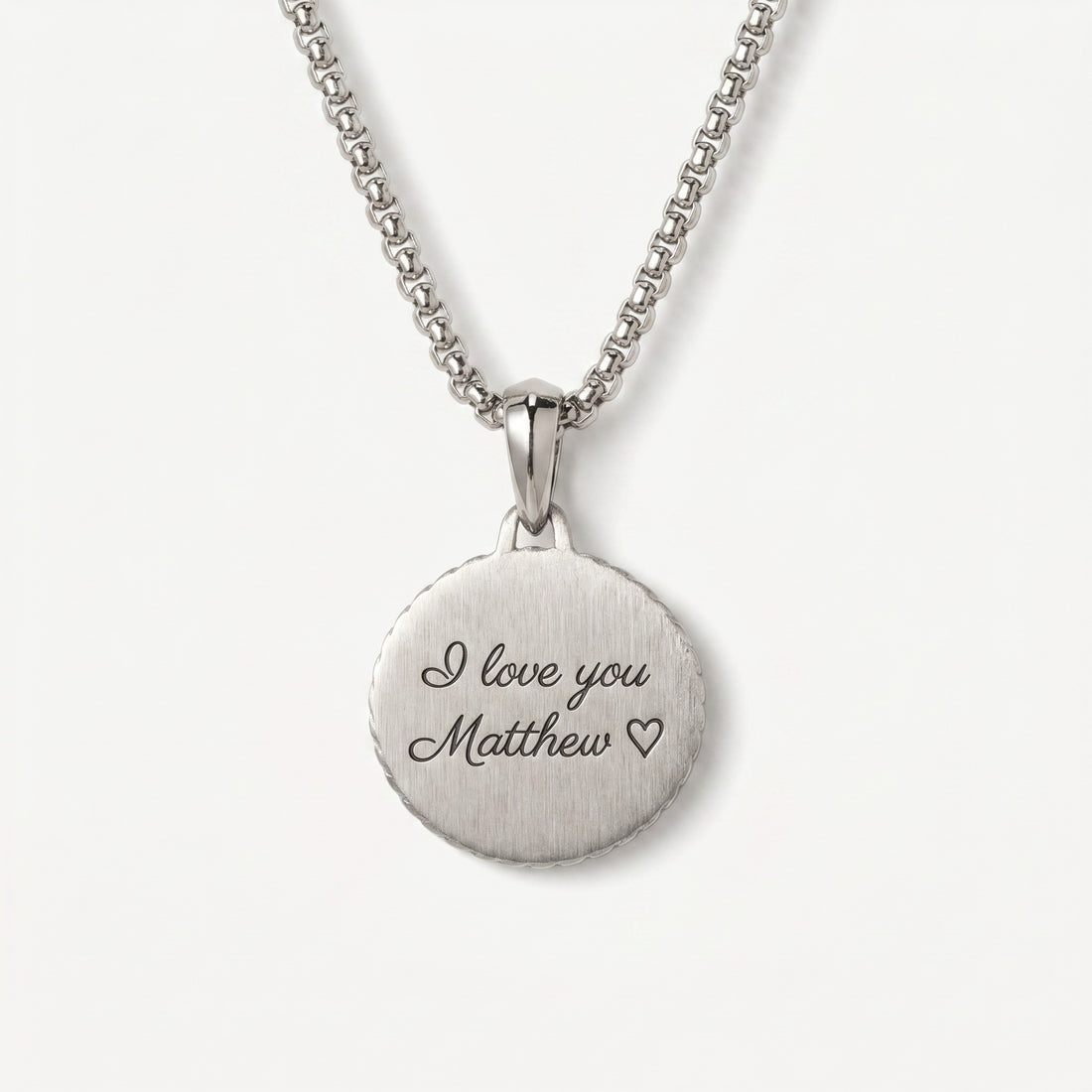 Silver necklace with a round pendant engraved with 'I love you Matthew' on a white background