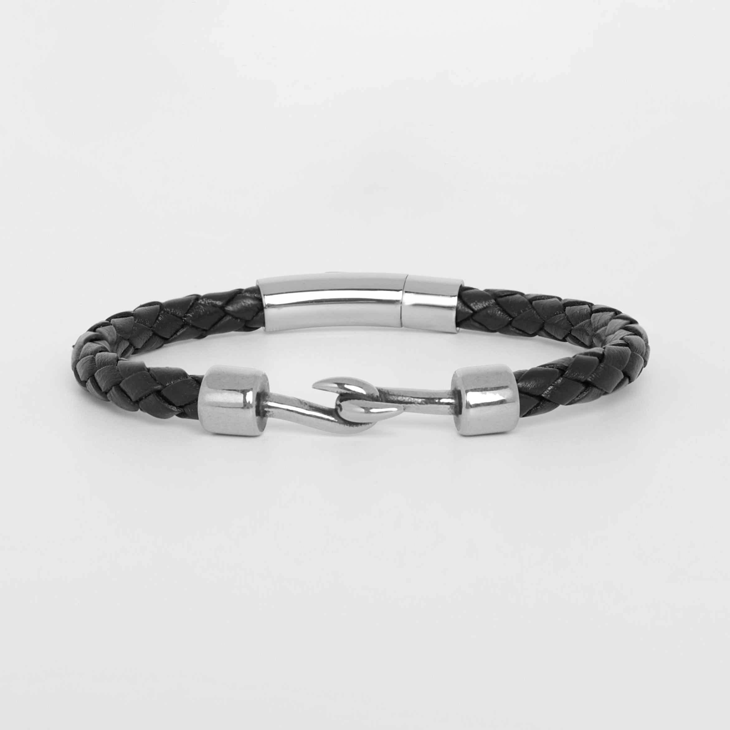 A black braided leather bracelet with polished silver-tone metal accents and a toggle clasp, displayed on a clean light gray background.