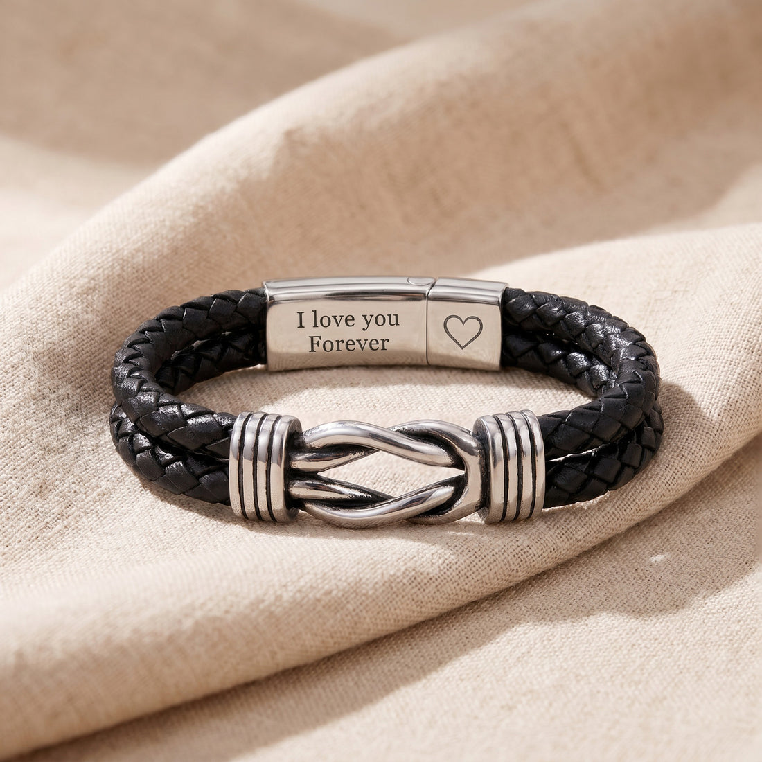 Black braided leather bracelet with silver clasp and 'I love you Forever' message on beige fabric