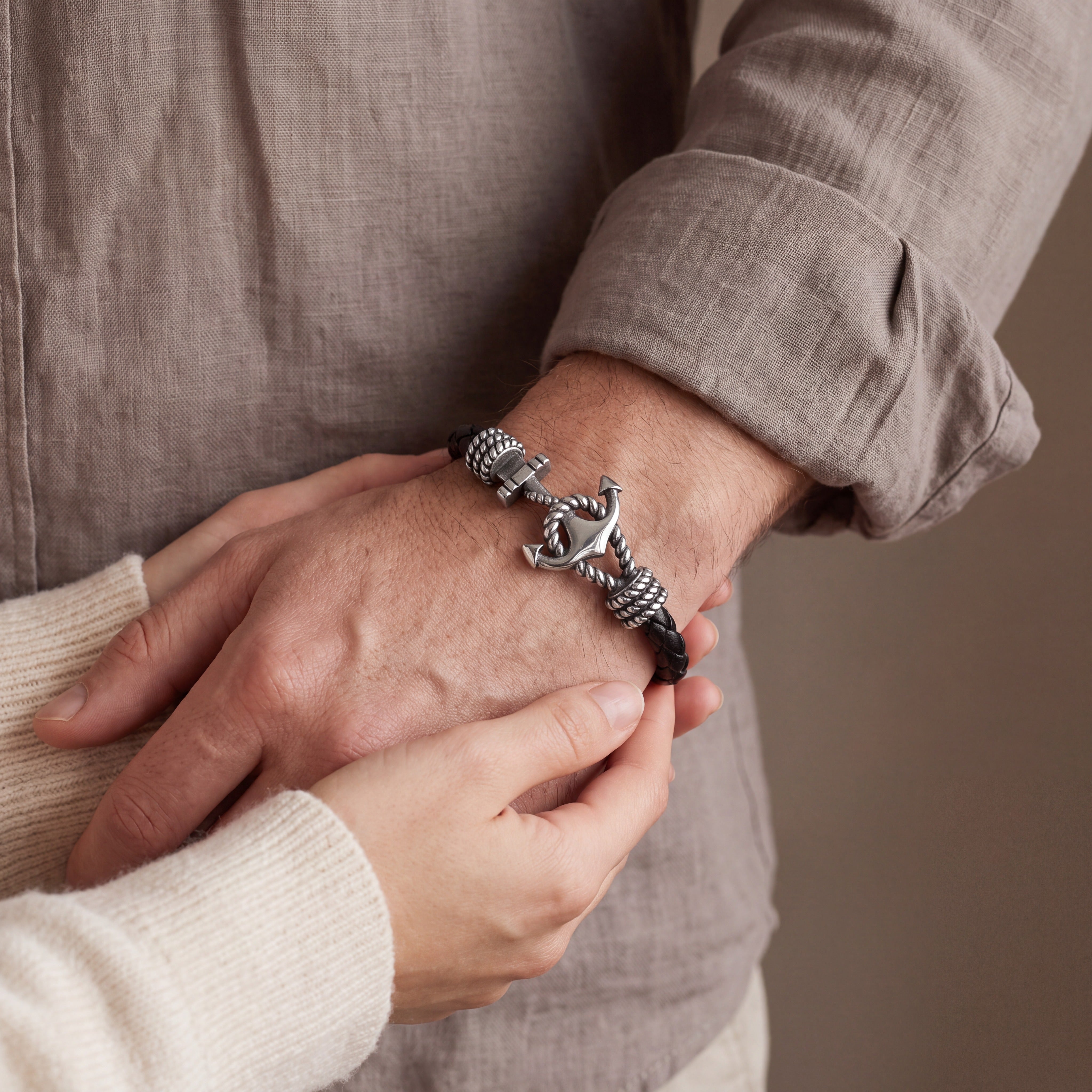 Open clasp showing a hidden name engraved inside a men's anchor bracelet