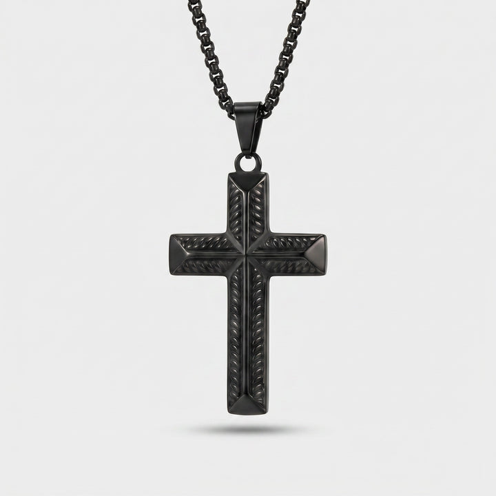 Black cross pendant necklace on a light gray background