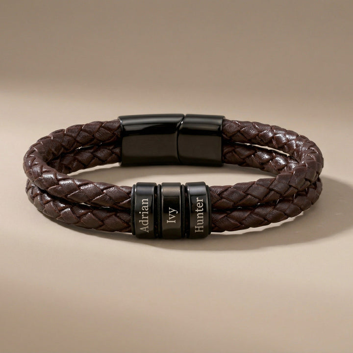 Brown braided leather bracelet with black magnetic clasp on a beige background