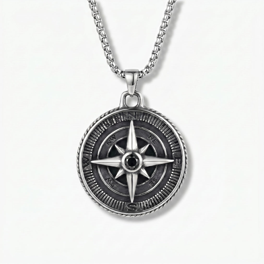 Silver compass pendant necklace on a white background