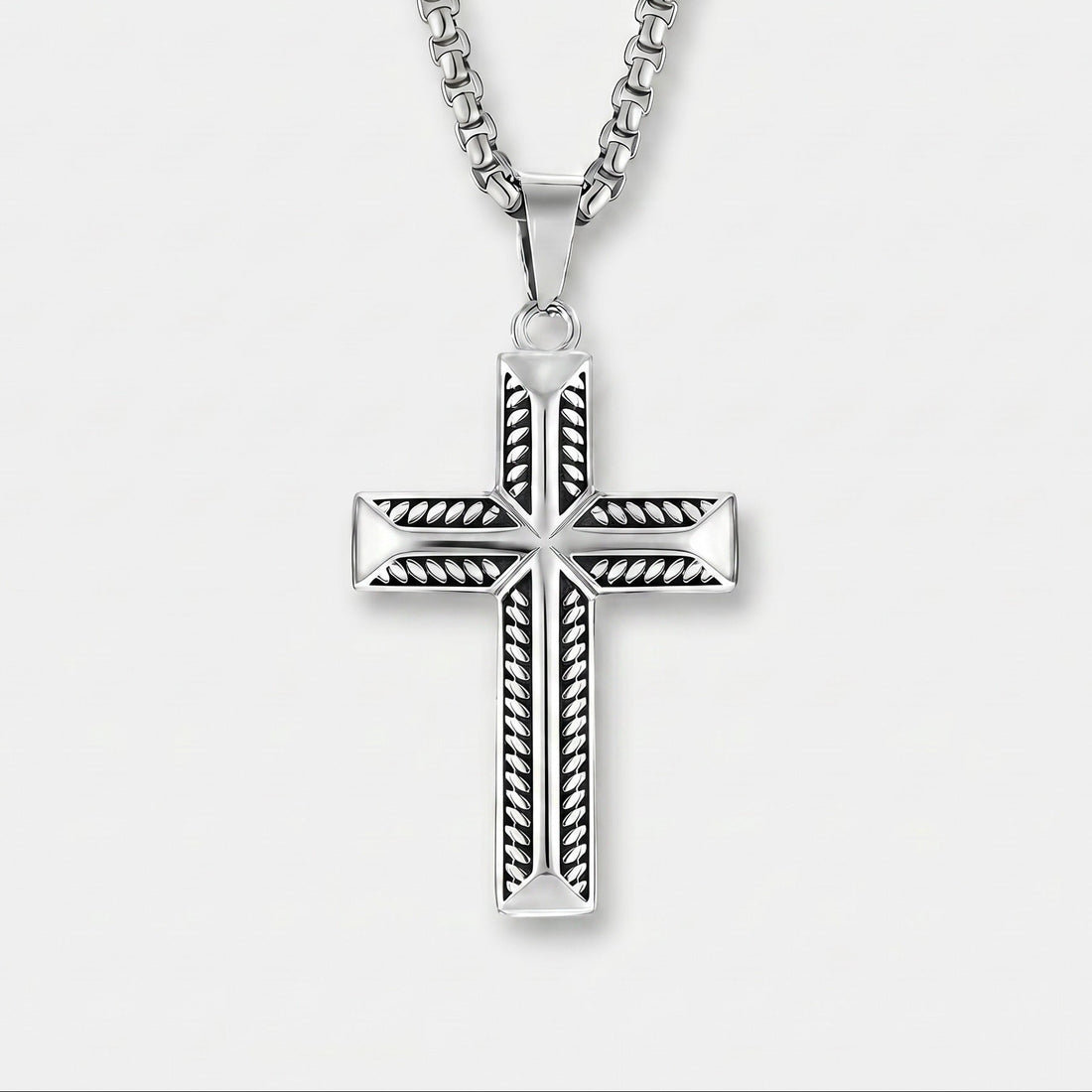 Silver cross pendant necklace on a white background
