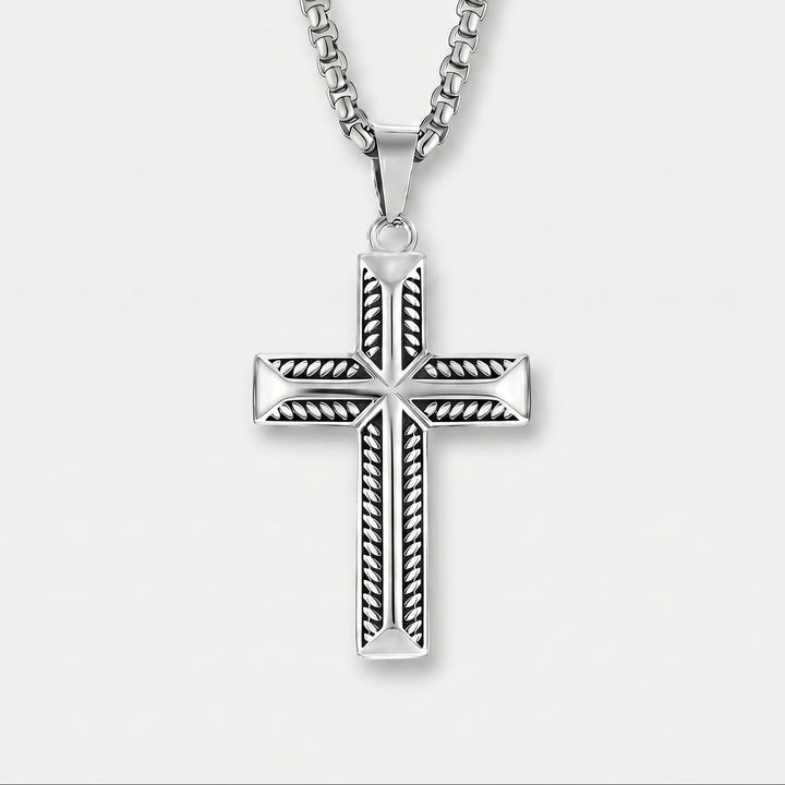 Silver cross pendant necklace on a white background
