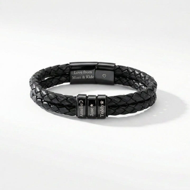 Black braided leather bracelet with engraved metal tags on a white background