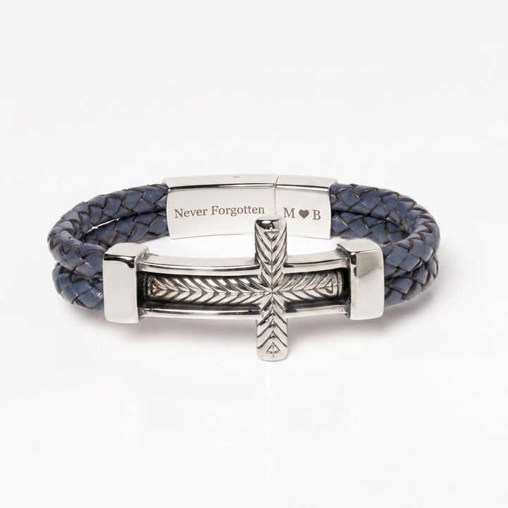 Blue braided leather bracelet with silver clasp and cross charm on a white background