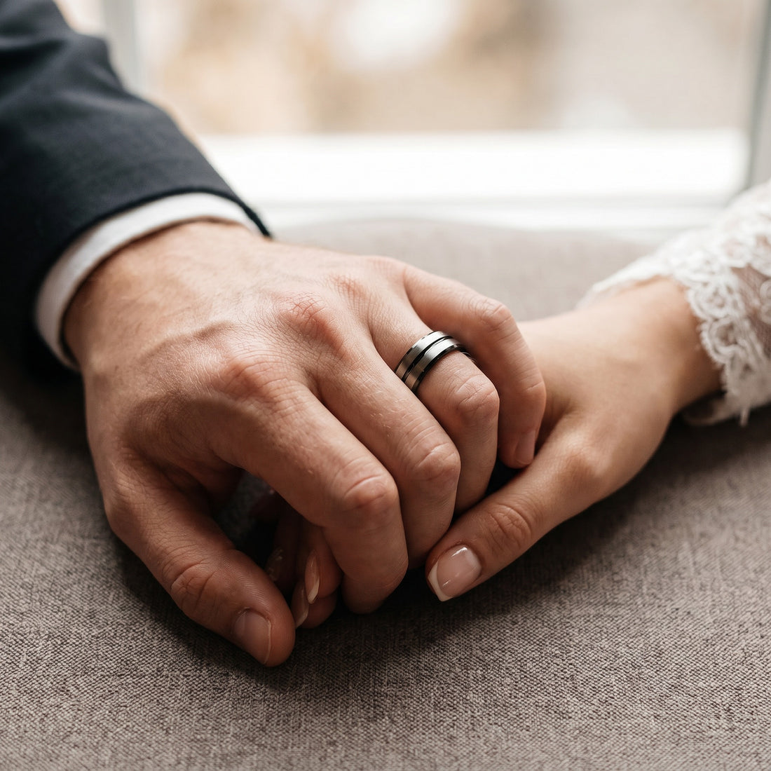 Two hands holding each other with a blurred background