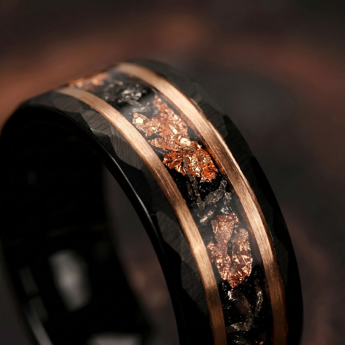 Close-up of a ring with metallic inlay on a dark background