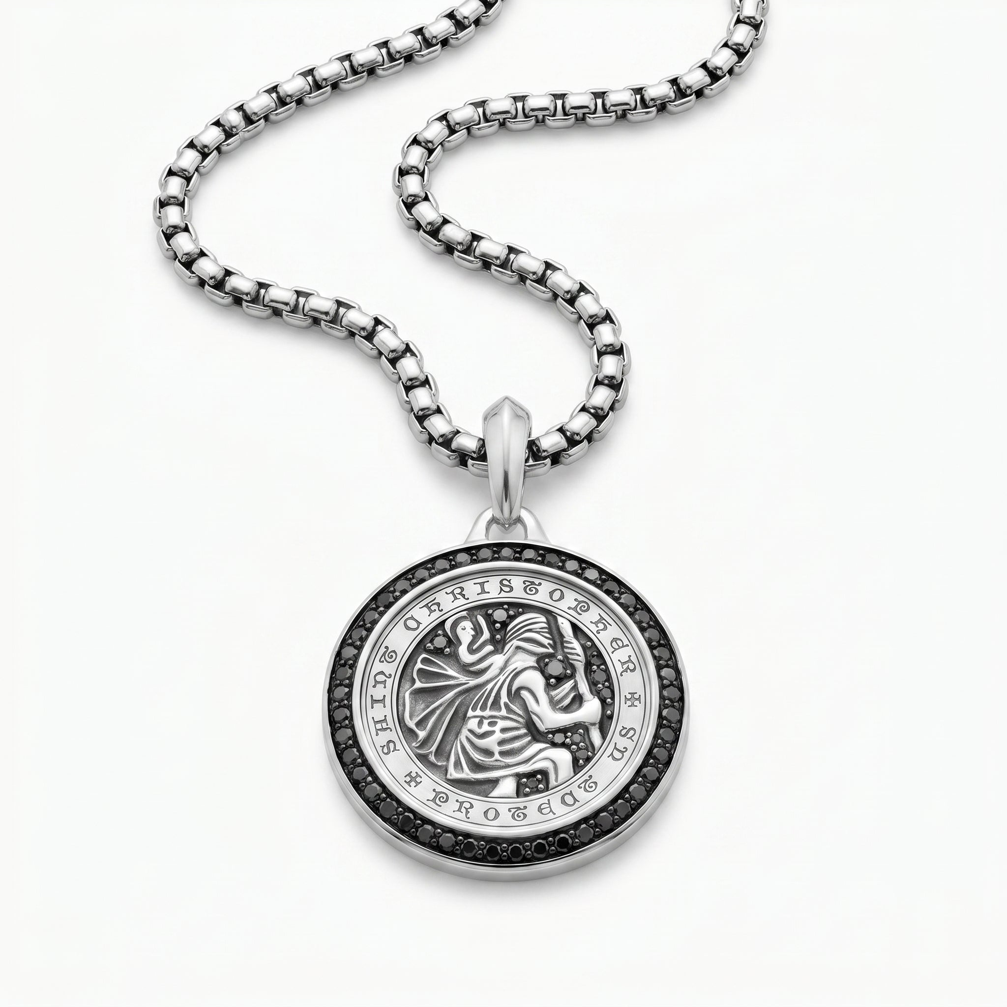 Silver pendant necklace with intricate design on a white background
