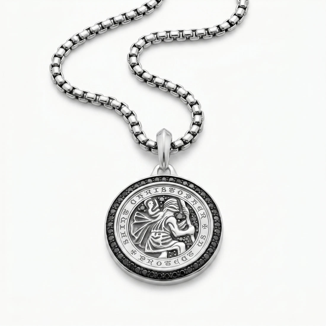 Silver pendant necklace with intricate design on a white background