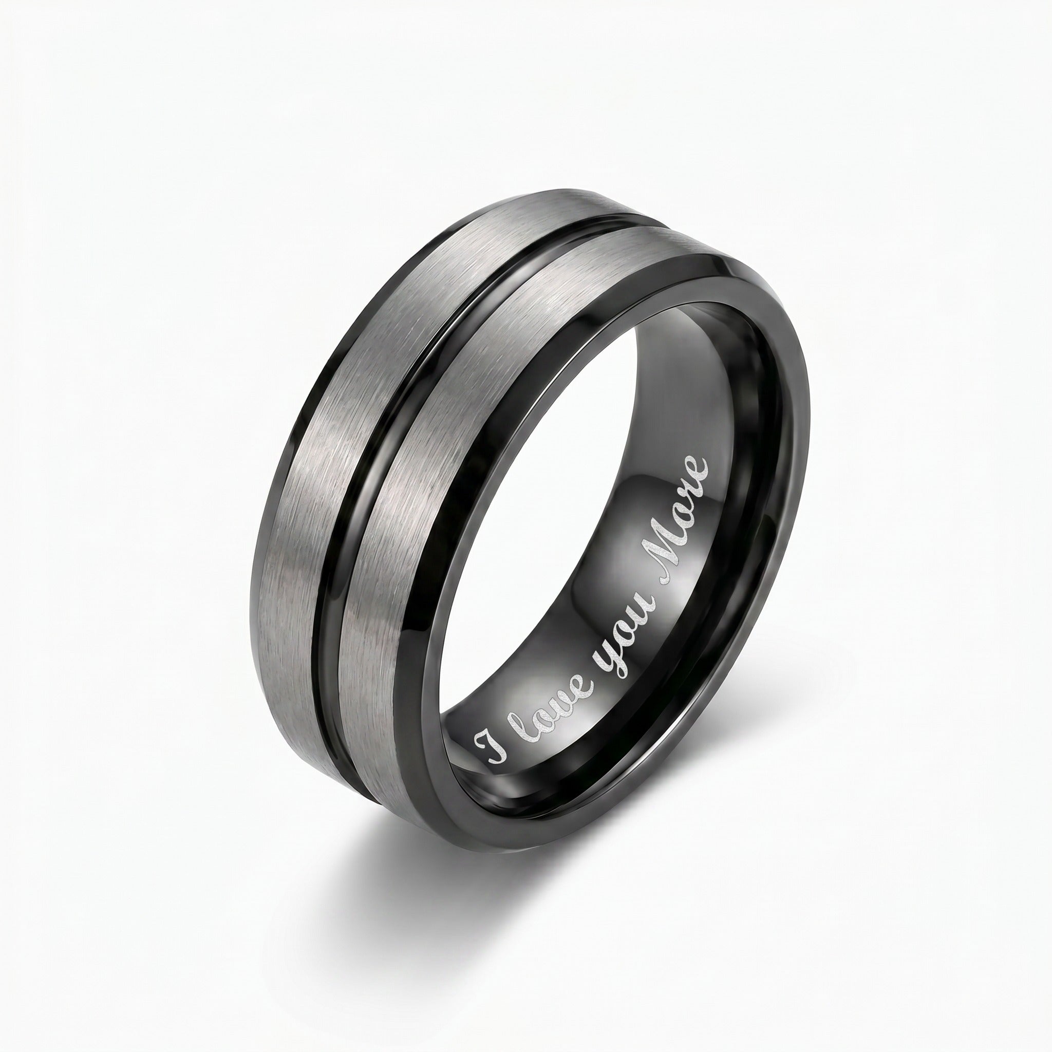 Silver and black ring with 'I love you more' engraving on a white background