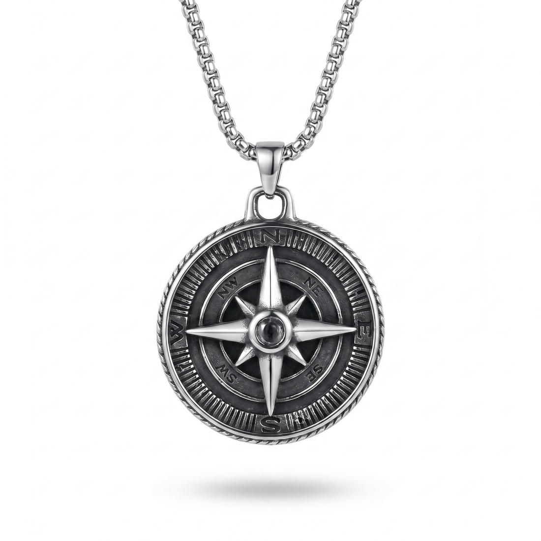 Silver compass pendant necklace on a white background