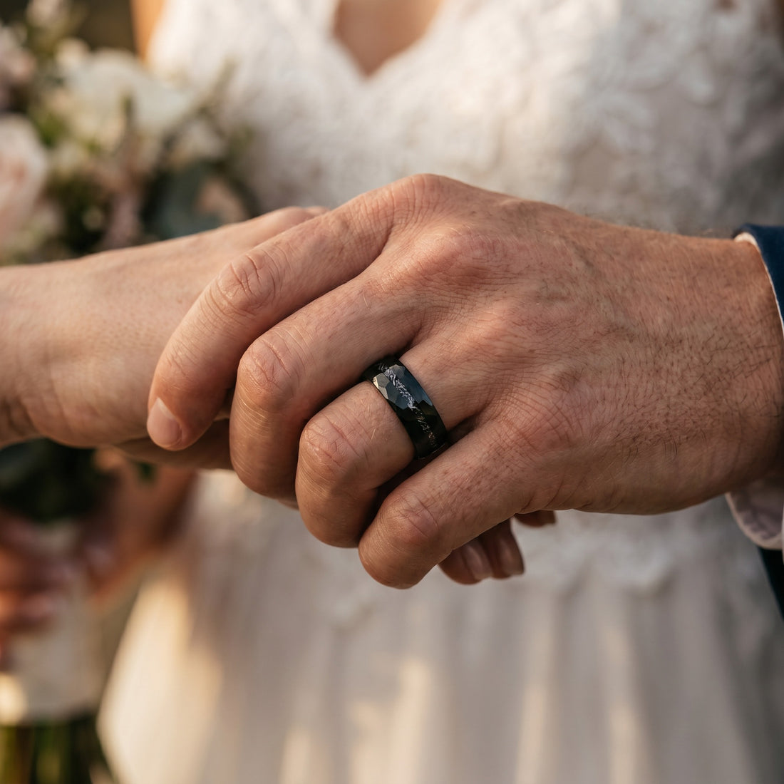 Close-up of two hands holding each other with a blurred background