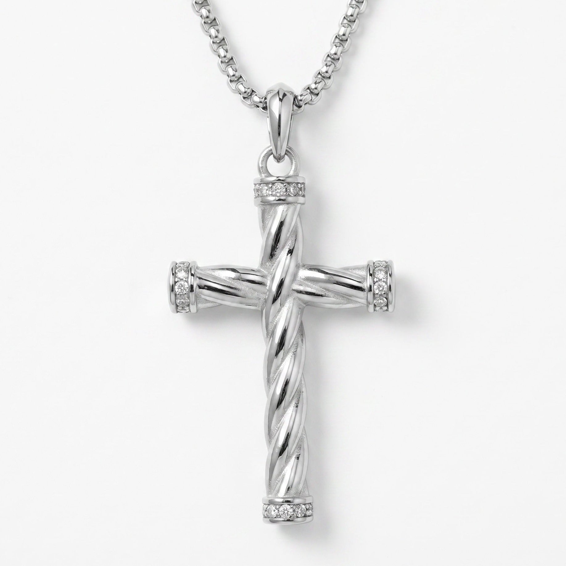 Silver cross pendant necklace on a white background