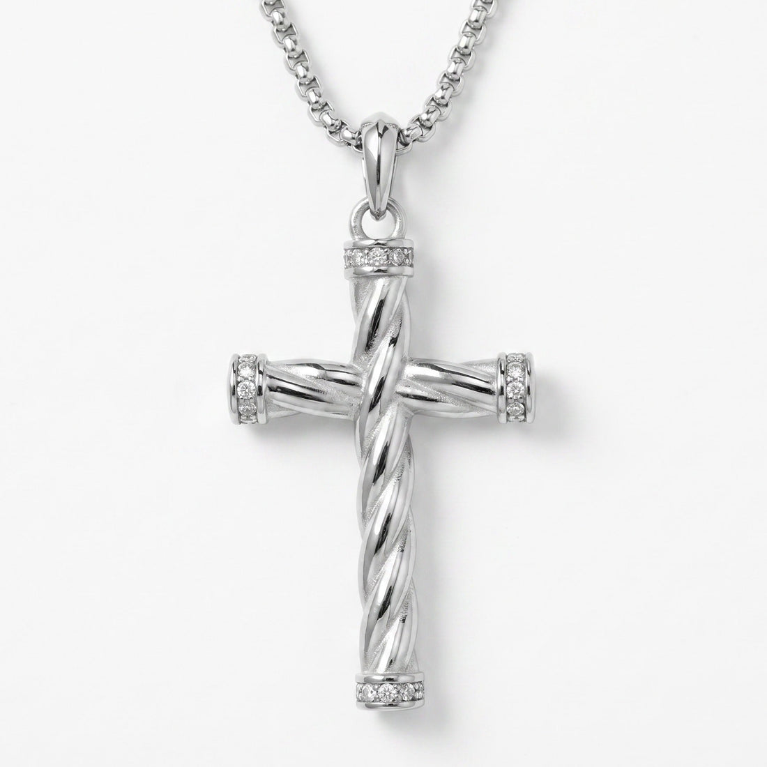 Silver cross pendant necklace on a white background
