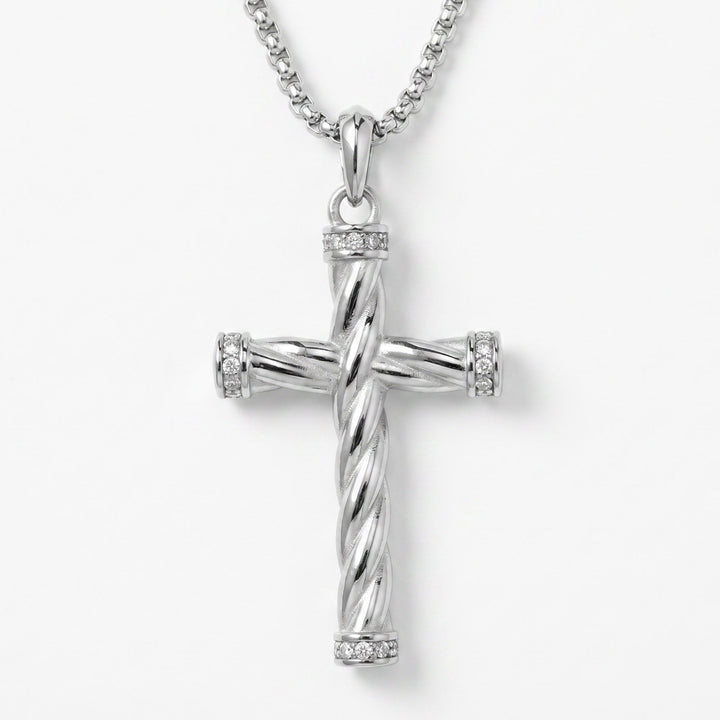 Silver cross pendant necklace on a white background